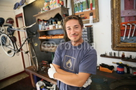 Naklejki Portrait of smiling business owner in bicycle shop