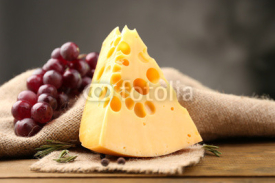 Naklejki Piece of cheese with grape and rosemary