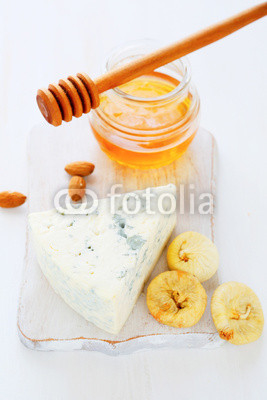 cheese, honey on a white chopping board