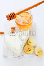 Naklejki cheese, honey on a white chopping board