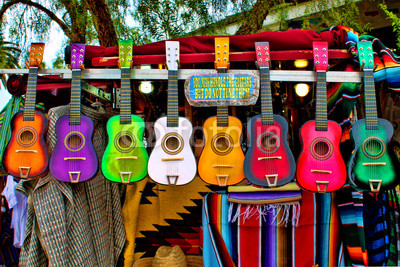 Colorful Ukeleles on an outdoor cart