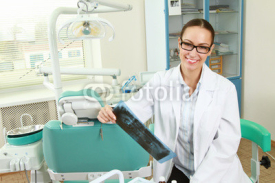 A dentist holding an x-ray.