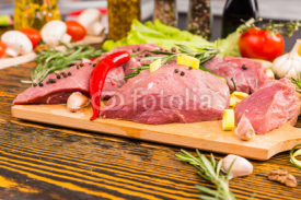 Naklejki Cutting board full of raw meat