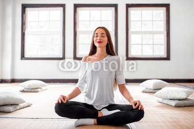 Woman practicing yoga indoors