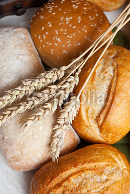 Freshly baked traditional rolls with ears of wheat grain
