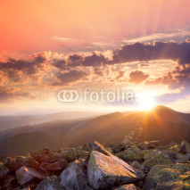 Naklejki Sunset in the mountains landscape. Dramatic sky,  colorful stone