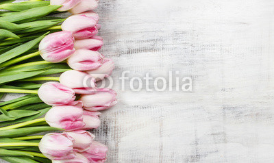 Beautiful pink and white tulips on wooden background. Copy space