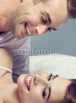 young attractive happy couple on the bed
