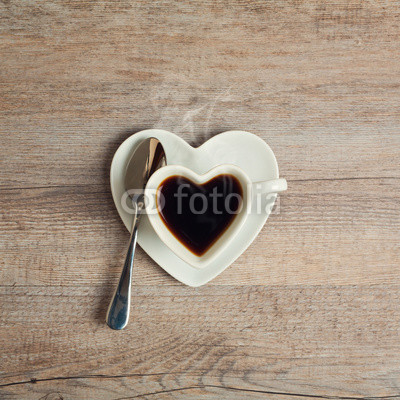Heart shape coffee cup on wooden table