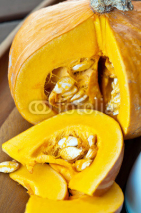 Naklejki Sliced ripe yellow pumpkin. Closeup.