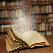 Opened magic book with magic light