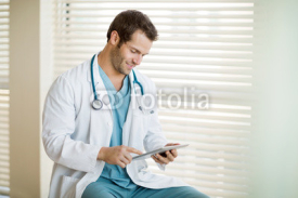 Naklejki Cancer Specialist Using Digital Tablet At Clinic