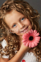 Beautiful curly little girl with gerbera daisy