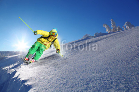 Naklejki Skier against blue sky in high mountains