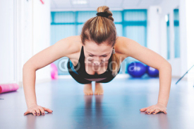 Fototapety Fitness woman doing exercise, push ups