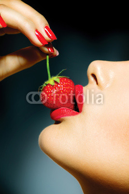 Sexy Woman Eating Strawberry. Sensual Red Lips