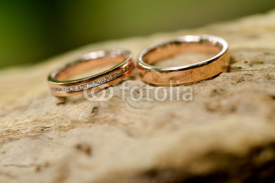 Fototapety Gold wedding ring placed on a stone surface