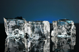 Obrazy i plakaty Ice cubes on dark blue background