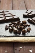Naklejki Pieces of chocolate on slate plate