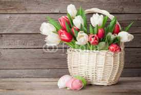 Colorful tulips bouquet basket and easter eggs