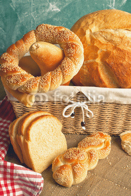 Delicious bread and rolls in wicker basket