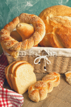 Naklejki Delicious bread and rolls in wicker basket
