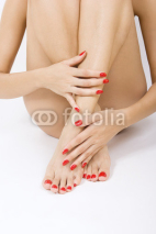 female foot with red pedicure - - red manicure and pedicure