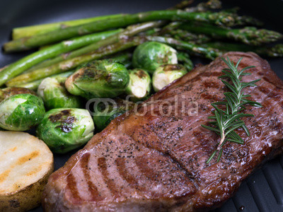 close up view of nice fresh steak with vegetables