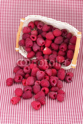 fresh redraspberry with leafs in basket