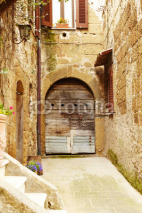 Fototapety Vintage street decorated with flowers, Tuscany, Italy