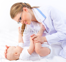 Fototapety Beautiful baby at the doctor pediatrician isolated on white