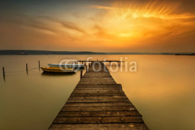 Fototapety Sunset view with boats at a lake coast near Varna, Bulgaria