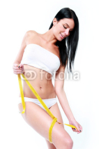 Sensual brunette girl with measuring tape