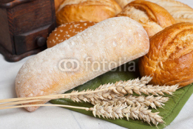 Obrazy i plakaty Freshly baked traditional rolls with ears of wheat grain