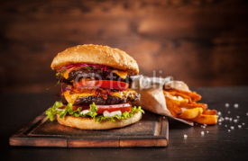 Obrazy i plakaty Fresh home-made hamburger served on wood