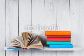 The open book and other multi-coloured books.