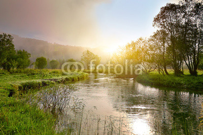 Sunrise on a smal river with fog