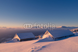 Wooden houses in snow