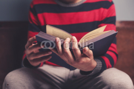 Fototapety Man is reading a big book