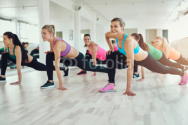 Fototapety women in colourful sportswear exercising