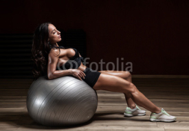 Fototapety young woman is engaged in bodybuilding