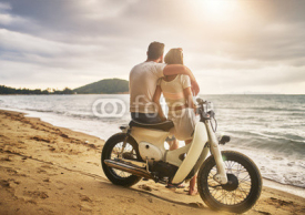 romantic couple sitting on vintage bike watching sunset at koh samui thailand