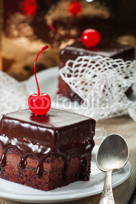 Chocolate coated fudge with candied cherry and lace