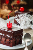 Fototapety Chocolate coated fudge with candied cherry and lace