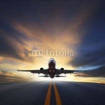 Naklejki passenger plane take off from runways against beautiful dusky sk