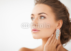 Naklejki woman wearing shiny diamond earrings