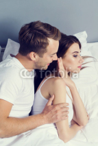 Unhappy young couple on the bed