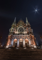 Fototapety Gothic church with fabulous facade during the night, with the Moon in the sky