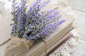 Naklejki Bunch of lavender placed on book bundle