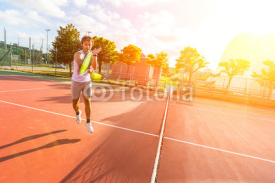 Naklejki Young Man Playing Tennis
